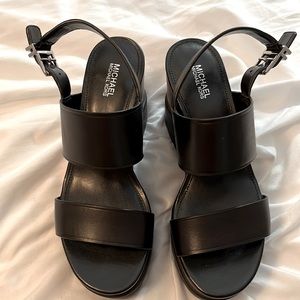 Michael Kors black leather wedgies with brown faux wood grain trim. 6 1/2 M.